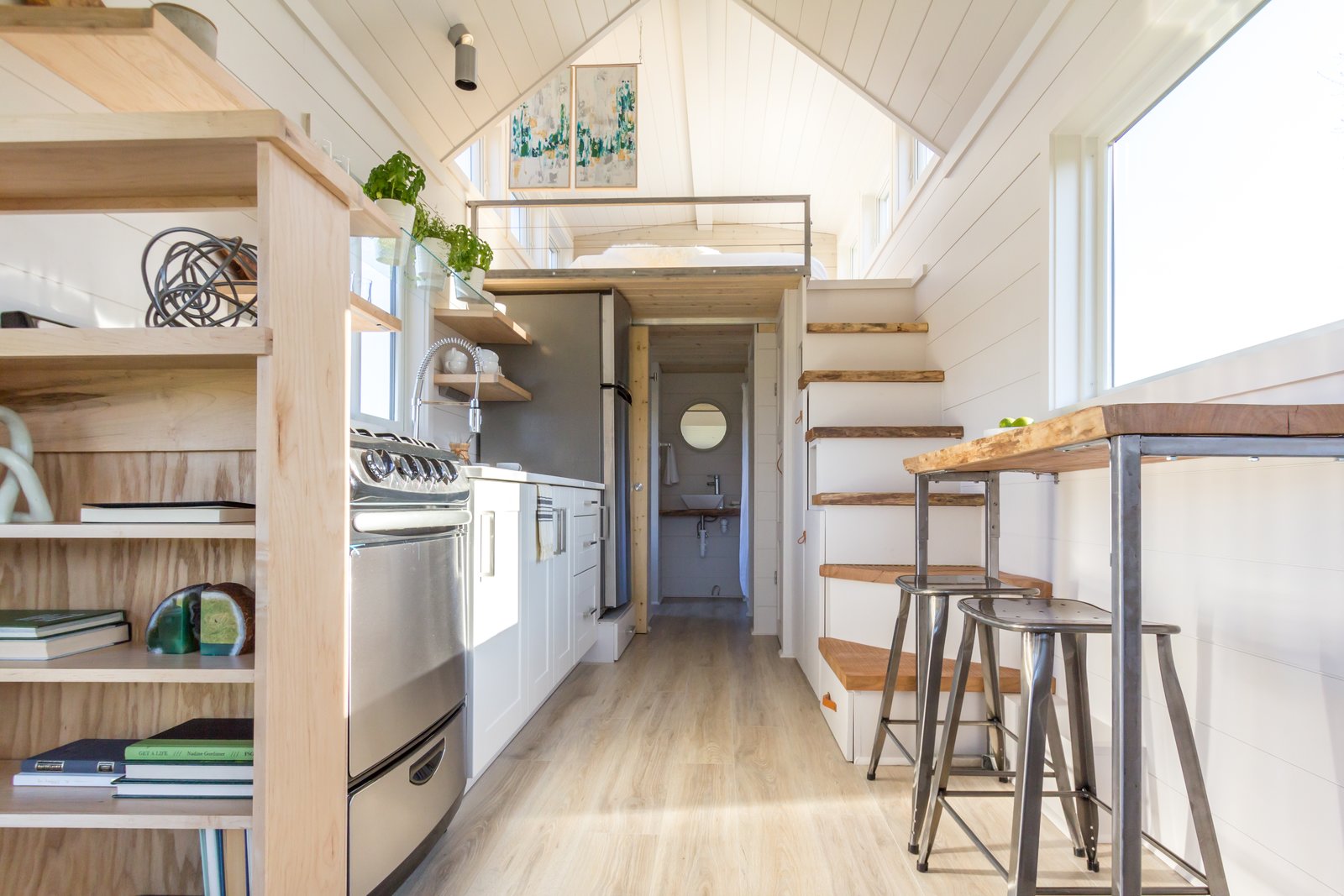 sunlight-bounces-off-white-painted-shiplap-walls-in-the-kitchen-and-the-sleeping-loft-the-flooring-is-from-pergo